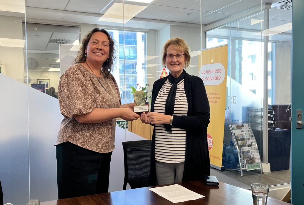 Karen from Age Concern NZ accepting the Wellbeing Award from Stacey Agnew.