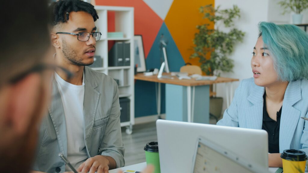 Leading through change and uncertainty 2 Two coworkers in a corporate setting having a serious conversation about change and uncertainty - by Vitaly Gariev, Unsplash.